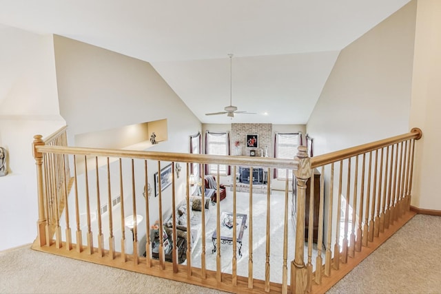 corridor featuring lofted ceiling and carpet