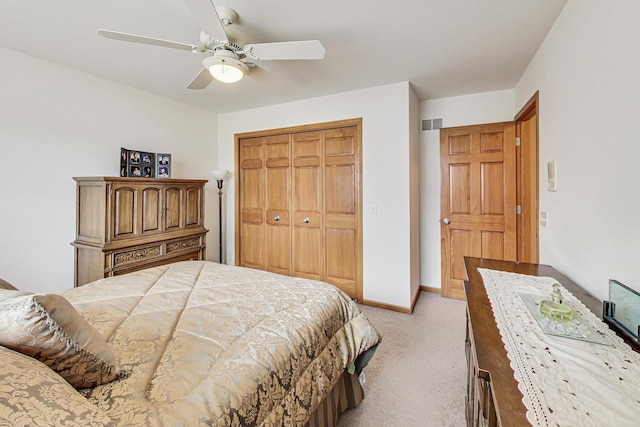 carpeted bedroom featuring a closet and ceiling fan