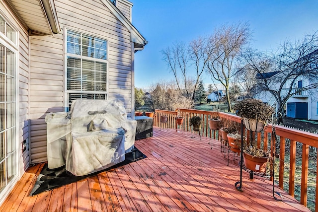 wooden deck with a grill