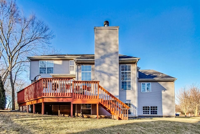 rear view of property featuring a wooden deck and a yard