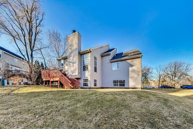 back of house featuring a yard and a deck