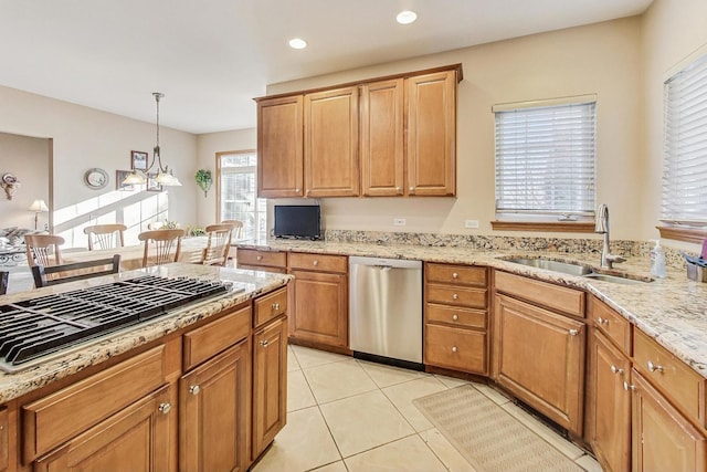 kitchen featuring pendant lighting, sink, light tile patterned floors, black gas stovetop, and stainless steel dishwasher