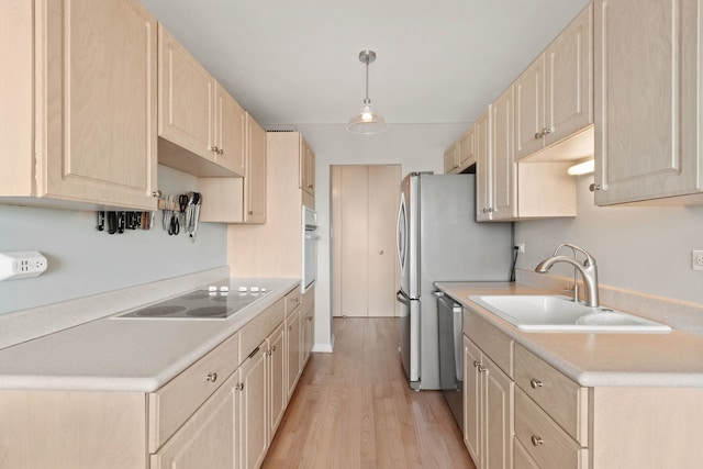 kitchen with sink, dishwasher, electric cooktop, decorative light fixtures, and light brown cabinets