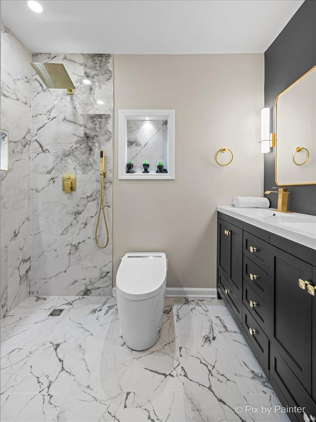 bathroom with vanity, toilet, and tiled shower