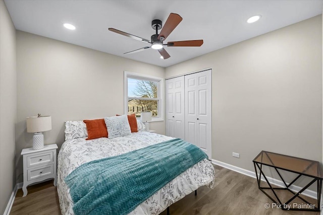 bedroom featuring hardwood / wood-style floors, ceiling fan, and a closet