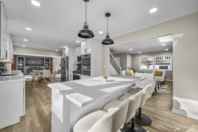 dining room featuring sink and light hardwood / wood-style flooring