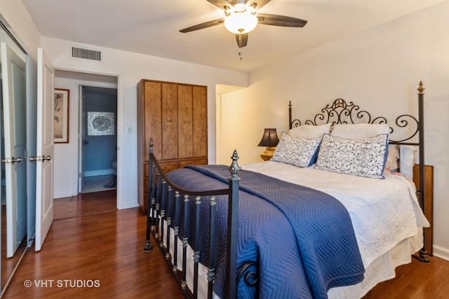 bedroom featuring baseboards, visible vents, ceiling fan, and wood finished floors