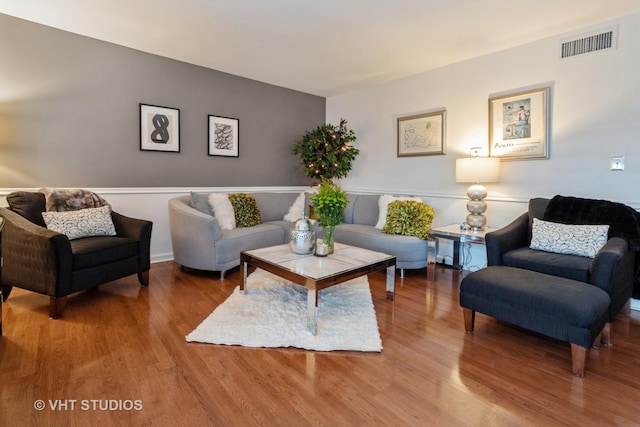 living room with visible vents and wood finished floors