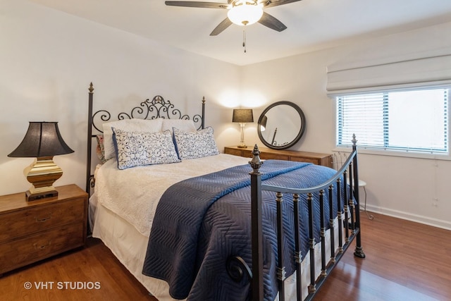 bedroom featuring ceiling fan, baseboards, and wood finished floors