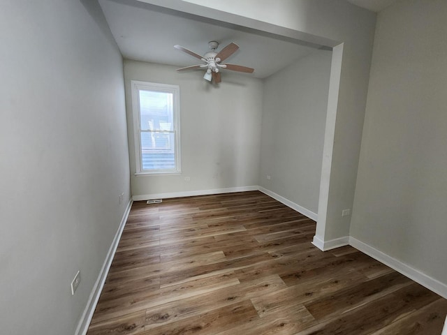 empty room with ceiling fan and hardwood / wood-style floors