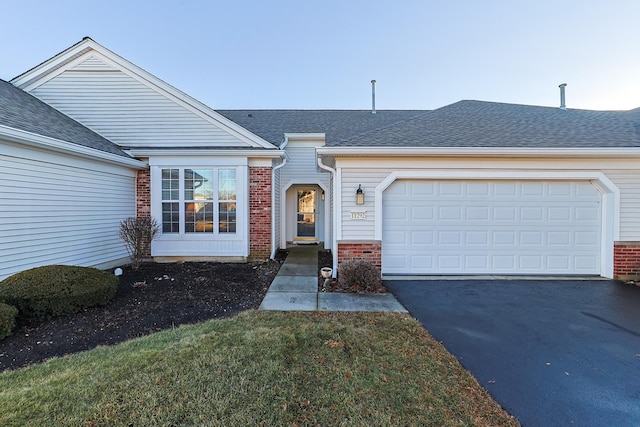 single story home featuring a garage and a front yard