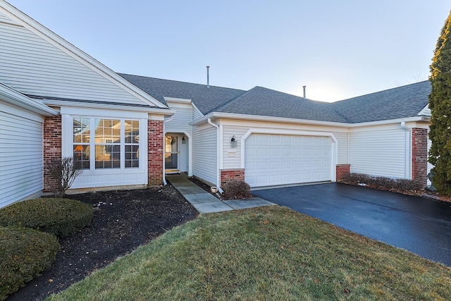 single story home with a garage and a front yard