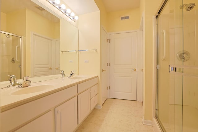 bathroom featuring vanity and a shower with shower door