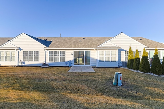 back of property featuring central AC unit, a lawn, and a patio