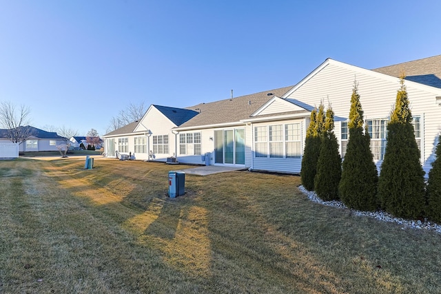 back of house with a patio area and a lawn