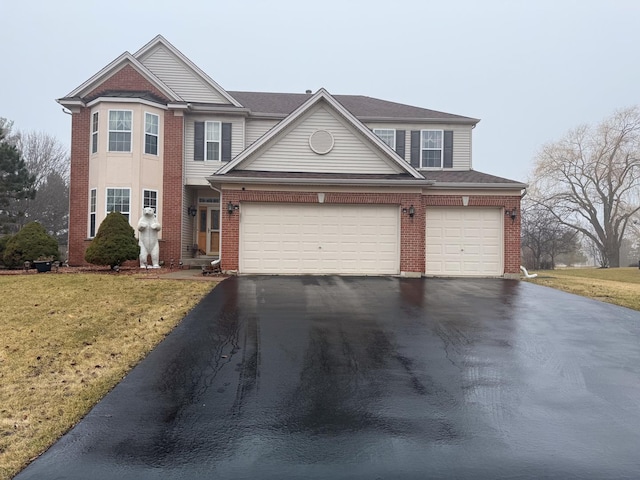 view of front of property with a garage and a front lawn