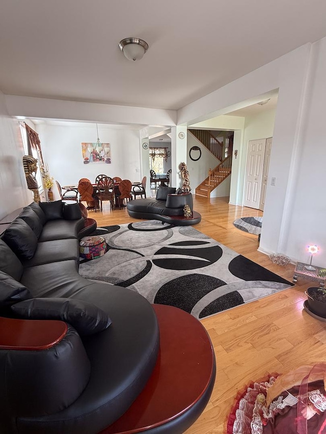 living room with an inviting chandelier and wood-type flooring