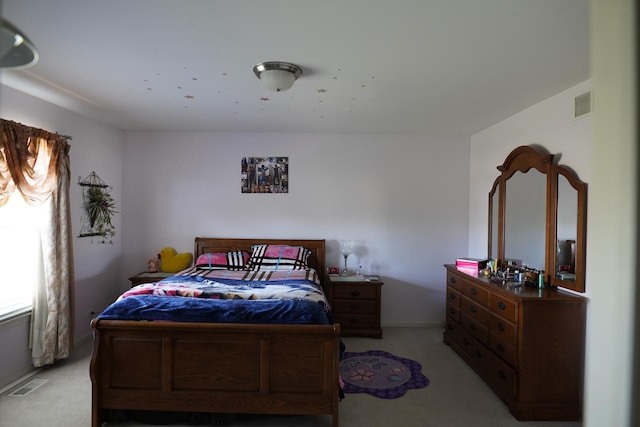 bedroom featuring light carpet