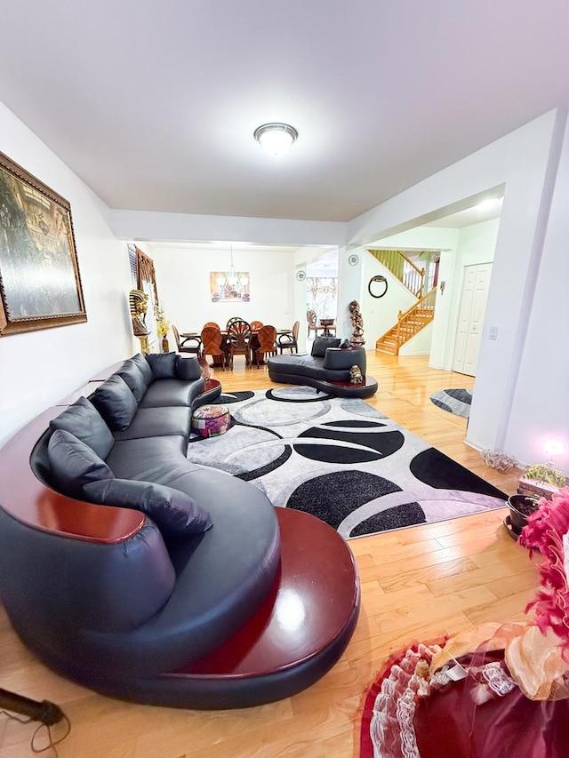 living room featuring an inviting chandelier and wood-type flooring