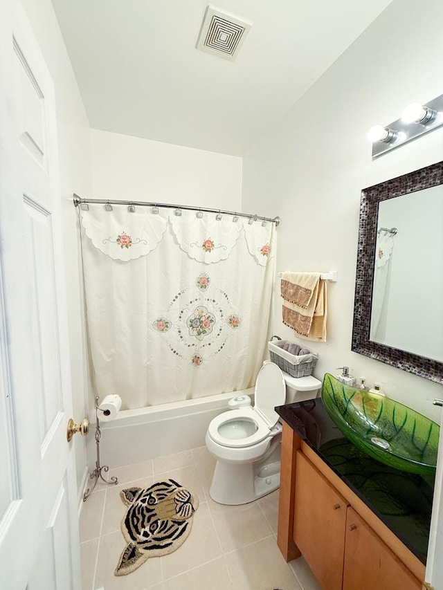 full bathroom featuring tile patterned flooring, vanity, shower / tub combo, and toilet