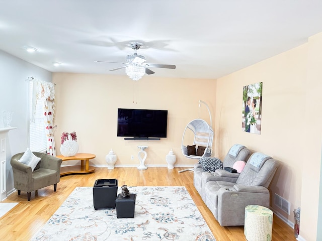 living room featuring hardwood / wood-style flooring and ceiling fan