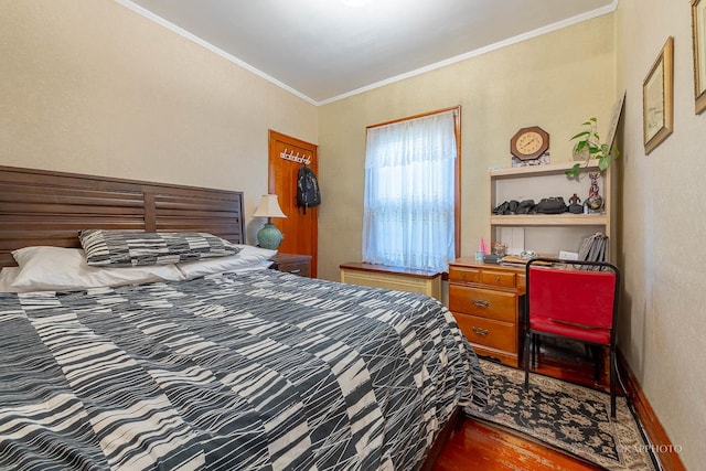 bedroom featuring hardwood / wood-style flooring and ornamental molding