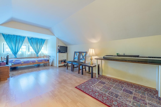 bedroom with hardwood / wood-style flooring and vaulted ceiling