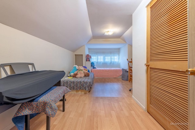 bedroom featuring lofted ceiling and light hardwood / wood-style flooring