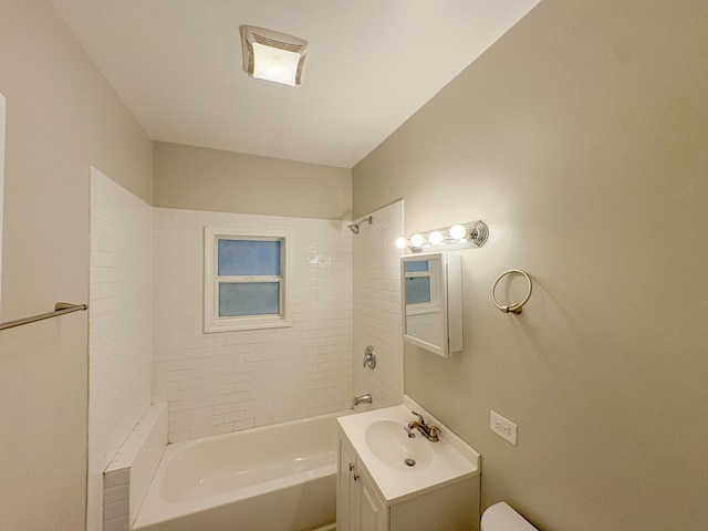 full bathroom featuring vanity, toilet, and tiled shower / bath combo