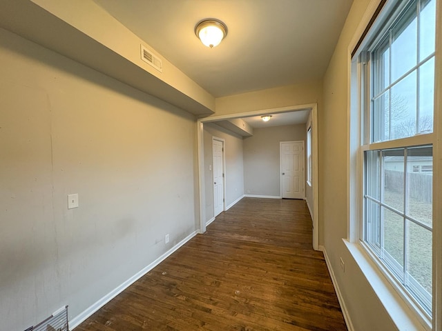 corridor featuring dark wood-type flooring