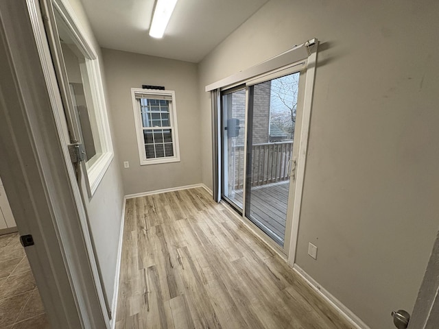 empty room with light hardwood / wood-style flooring