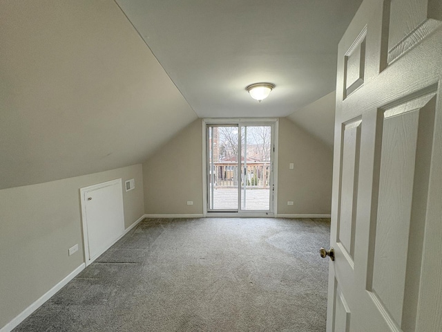 bonus room featuring vaulted ceiling and carpet