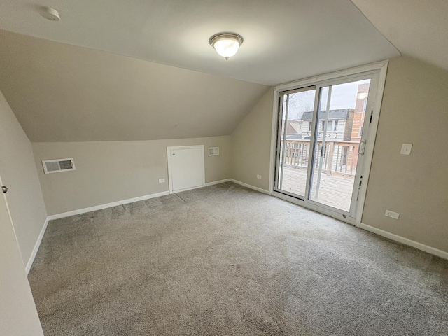 bonus room featuring lofted ceiling and carpet flooring