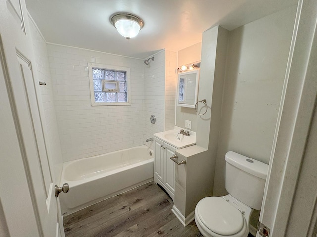 full bathroom with vanity, toilet, hardwood / wood-style floors, and tiled shower / bath