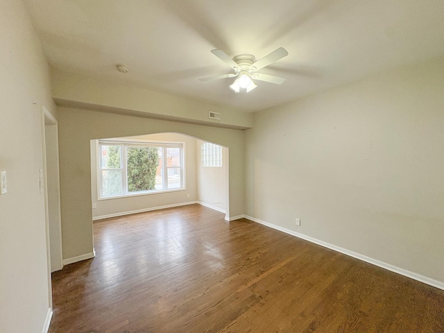 unfurnished room featuring ceiling fan and dark hardwood / wood-style flooring