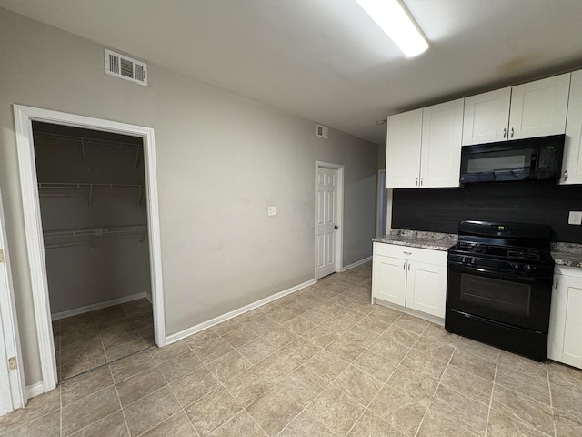 kitchen featuring white cabinetry, backsplash, light stone counters, and black appliances