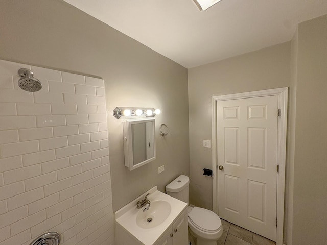 bathroom with tile patterned flooring, vanity, and toilet