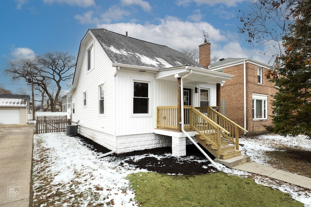 view of front of house featuring an outbuilding, central AC unit, and a garage