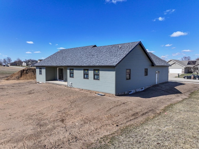 rear view of property with a shingled roof