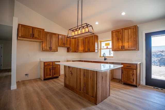 kitchen with brown cabinetry, a sink, and a kitchen island