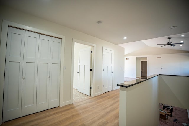 kitchen featuring light wood-type flooring, a ceiling fan, recessed lighting, and vaulted ceiling