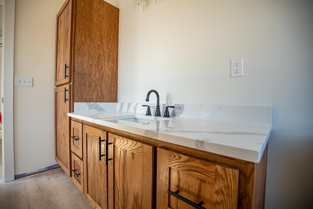 bathroom with vanity and wood finished floors