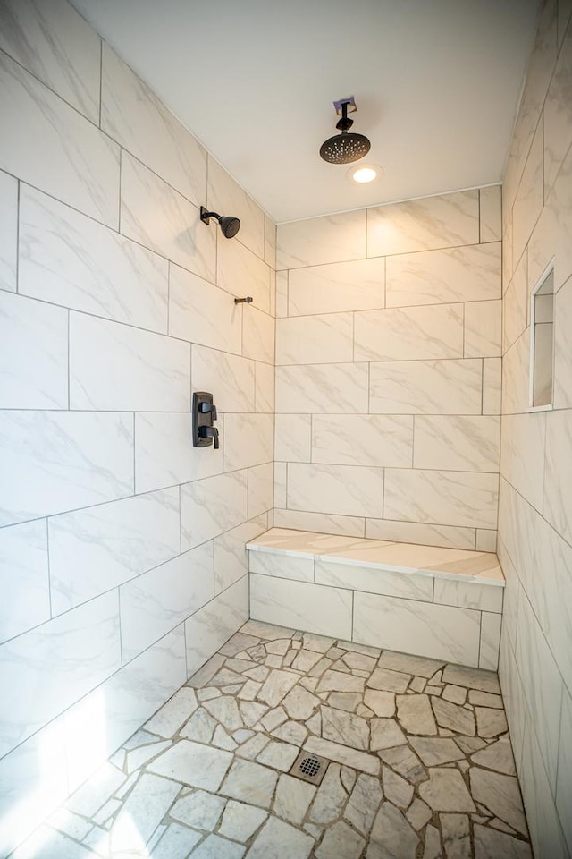 bathroom with tiled shower