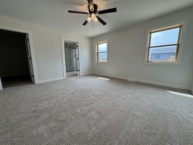 carpeted empty room with baseboards and ceiling fan