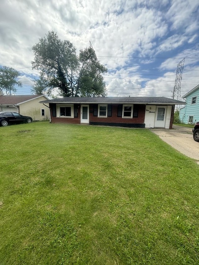 single story home with a garage and a front lawn