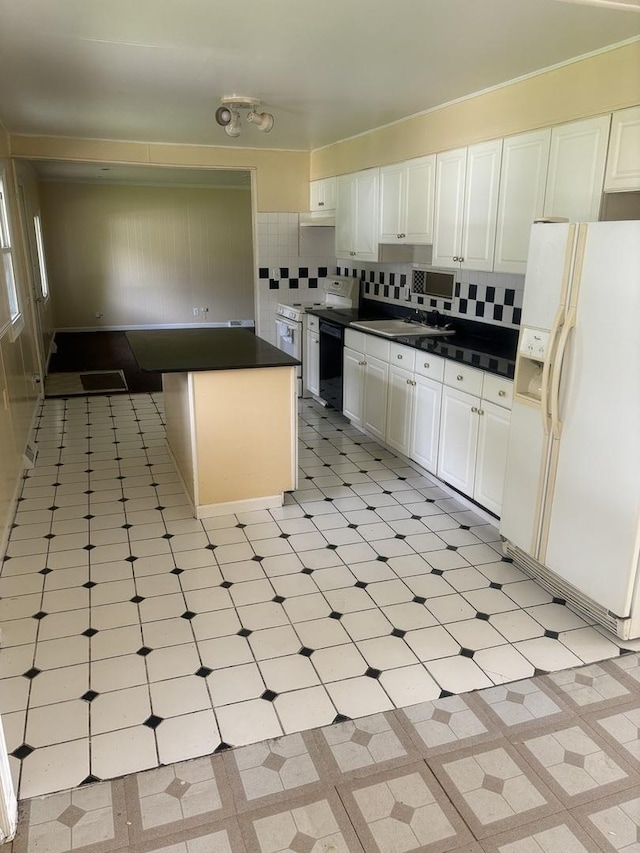 kitchen featuring tasteful backsplash, white cabinets, stove, and white fridge with ice dispenser