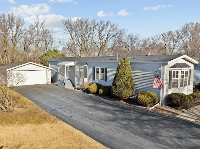 single story home with a garage and an outdoor structure