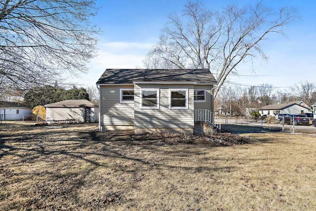 view of home's exterior with a yard and a shed