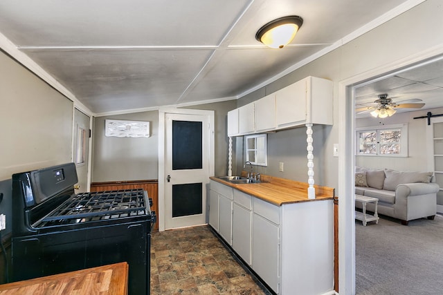 kitchen featuring sink, ornamental molding, black range with gas stovetop, ceiling fan, and white cabinets