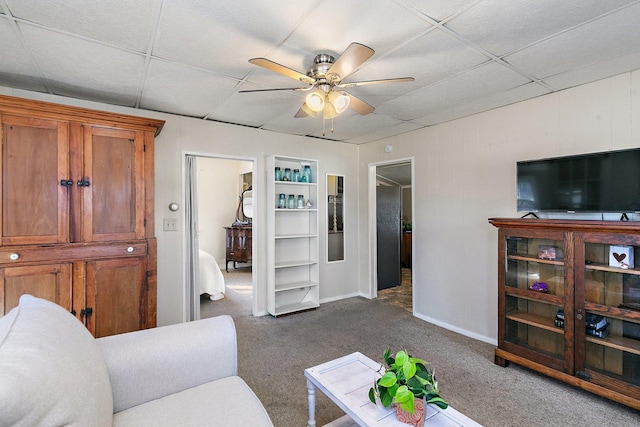 carpeted living room featuring a paneled ceiling and ceiling fan